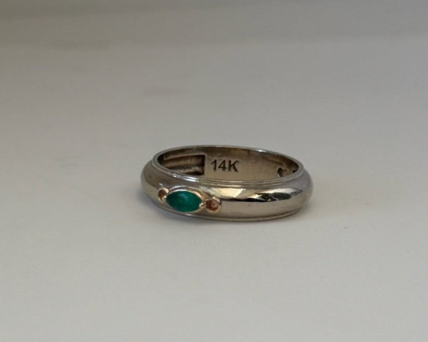 gold ring with a green gemstone 